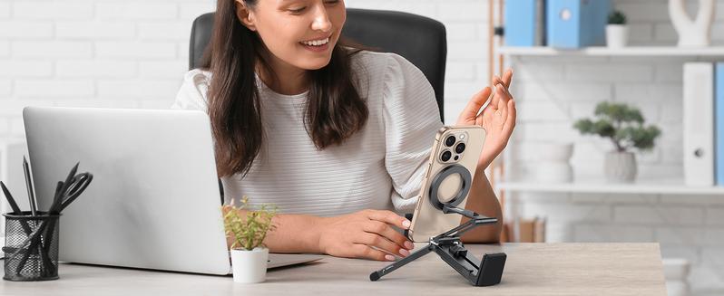 Woman using magnetic stand at desk