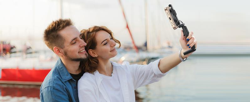 Couple taking selfie with magnetic stick
