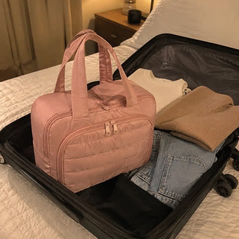Pink organizer packed in a carry-on suitcase