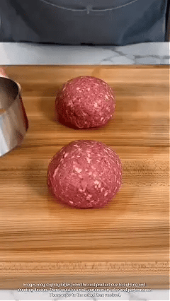 Manual burger patty press shaping a round burger Manual burger patty press shaping a round burger
